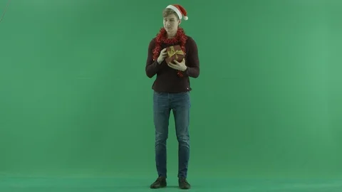 Happy man opens Christmas present, green chroma key background Stock Footage 86465919