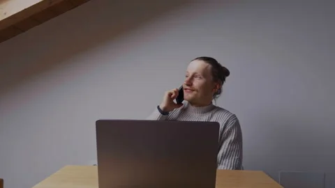 Happy man on phone call while working remotely on laptop Video stock 334735966