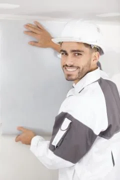 A happy man is plastering Stock Photos