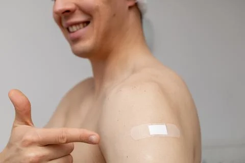 Happy man pointing at the patch on shoulder Stock Photos