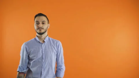 Happy man pointing at product, looking at the camera and smiling Stock Footage 138435840