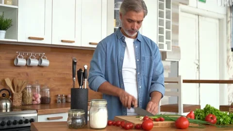 Happy man preparing romantic surprise, smiling husband cooking healthy food Stock Footage 139741787