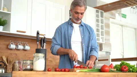 Happy man preparing romantic surprise, smiling husband cooking healthy food Stock Footage 139741854