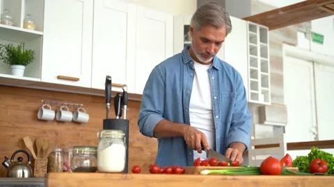 Happy man preparing romantic surprise, smiling husband cooking healthy food Stock Footage 139742005