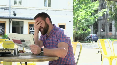 Happy man reading newspaper during lunch, slider shot 库存影片 67628665