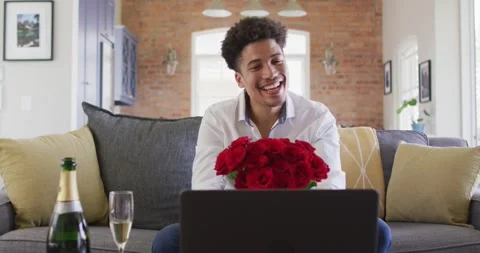 Happy man with red roses making valentine's day video call on laptop Stock Footage 335268358
