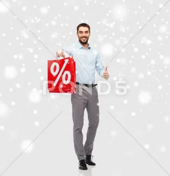 Happy man with red shopping bag showing thumbs up Stock Photos