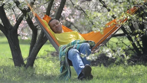Happy man relaxes in a hammock Stock-Footage 88946074