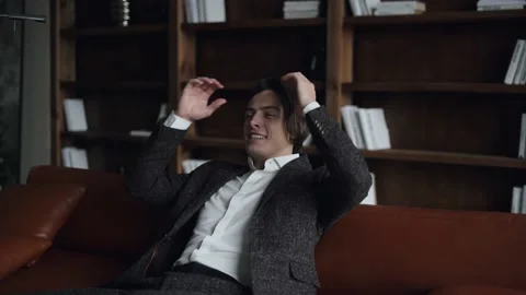 Happy man resting on sofa after work Stock Footage 168649485