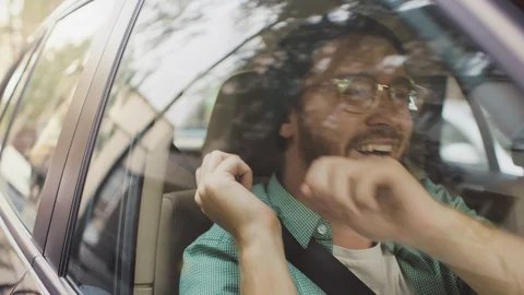 Happy Man Rides on a Passenger Seat of a Moving Car, Dances and Has Fun. Stock Footage