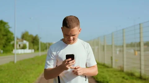 Happy man runner stopped checks mail use phone read good news and running Stock Footage 140365931