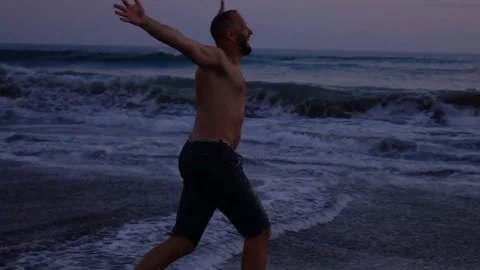 Happy man running on the beach and having fun, slow motion shot at 240fps, stead Stock-Footage 80412539