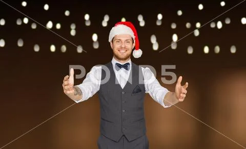 Happy man in santa hat holding something imaginary Stock Photos