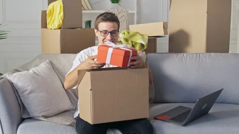 A happy man Satisfied By a Quick Delivery. Unpacking of Order From Online Shops Video stock 139060842