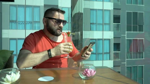 Happy man sitting in the cafe and using smartphone Stock Footage 88538739