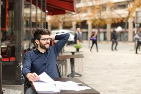 Happy man sitting at cafe table Stock Photos