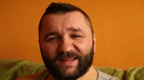 Happy man sitting on couch and smile Video stock 61302840