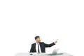 The happy man sitting at the desktop and gesturing on the white background Photo