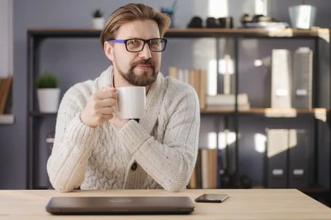 Happy man sitting at table with coffee and looking at camera Stock Photos