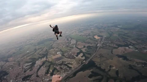 Happy man skydiving over the clouds at sunset Stock Footage 302391317