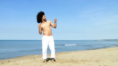Happy man slowly dancing on the beach slow motion Stock Footage 37821276