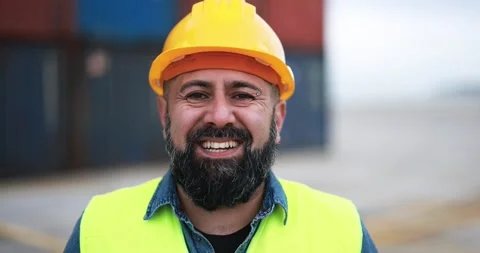 Happy man smiling on camera working at freight terminal port on background Stock Footage 179970577