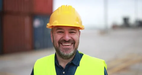 Happy man smiling on camera working at freight terminal port on background Stock Footage 179970812