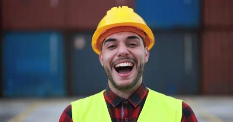 Happy man smiling on camera working with industrial port on background Video stock 179971687
