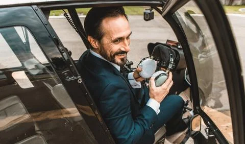Happy man smiling while sitting in the helicopter alone Stock-Fotos
