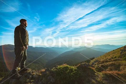 The happy man standing on the beautiful mountain landscape background Stock Photos