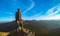 The happy man standing on the rock Photo