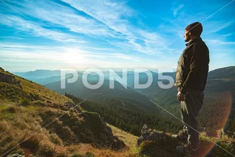 The happy man standing on the rock Stock Photos