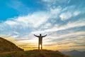 The happy man standing on the rock with a picturesque sunrise Photo