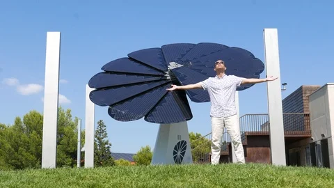 Happy Man stretched out arms, enjoy pure sun energy against solar panel Stock Footage 94957548