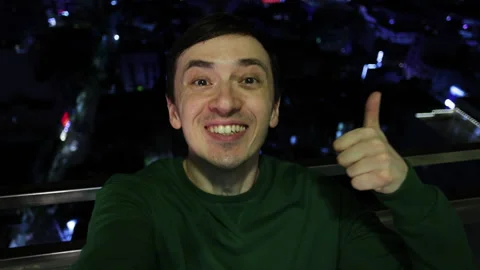 Happy man taking selfie video at night on rooftop Stock Footage 344283590