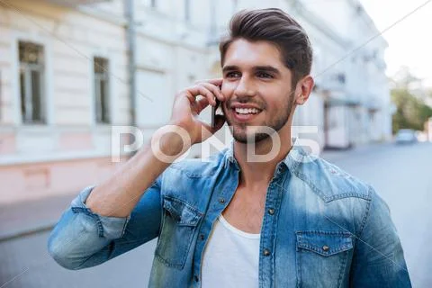 Happy man talking on cell phone outdoors Stock Photos