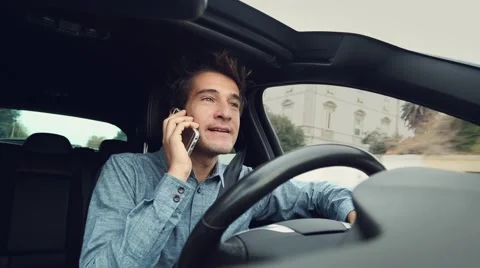 Happy man talking on the phone while driving car Stock Footage 58276808