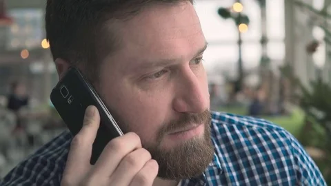 Happy man talking by smartphone, smiling at camera, portrait, in cafe, steadycam Vídeo Stock 72952222