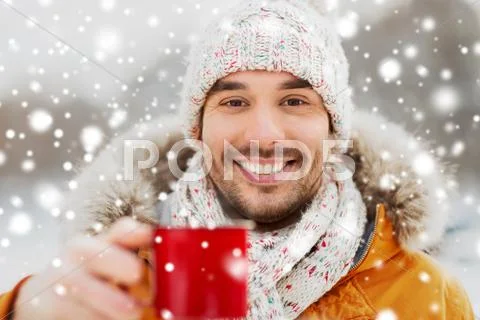 Happy man with tea cup outdoors in winter Stock Photos