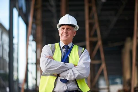Happy man, thinking and construction with arms crossed in city, foreman and Stock Photos