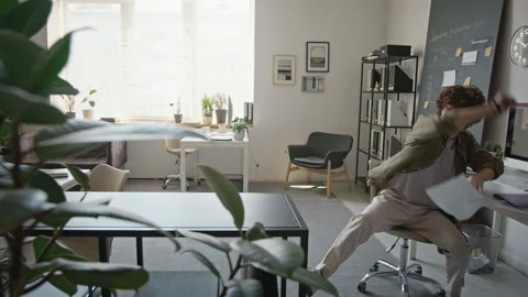 Happy Man Throwing Paperwork in Air and Dancing in Modern Office Stock Footage 345233697