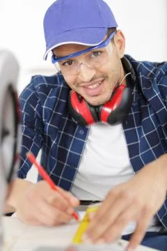 Happy man using circular saw Stock Photos