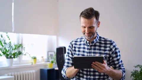 Happy man using digital tablet working from home office Stock Footage 126825128