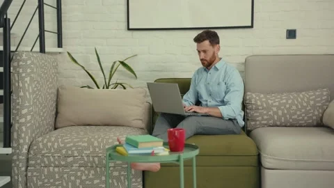 Happy man using laptop typing look at camera waving his hand wants to show Stock Footage 132539750