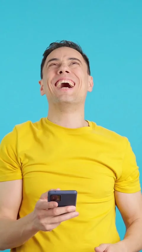 Happy man using the mobile phone and smiling Stock Footage 258204507