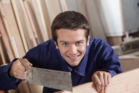 Happy man using a saw 스톡 사진