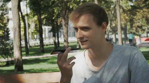 Happy man using a smart phone voice recognition audio ai message speech funct Stock Footage 114180529