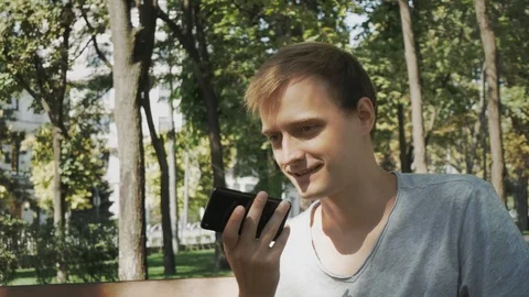 Happy man using a smart phone voice recognition audio ai message speech funct Stock Footage 114180560