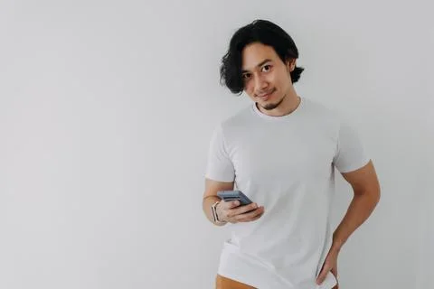 Happy man using smartphone on white background and copy space. Photos