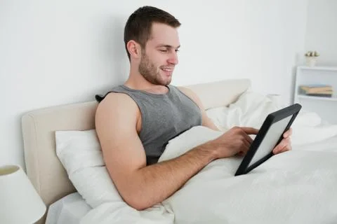 Happy man using a tablet computer Stockfoto's